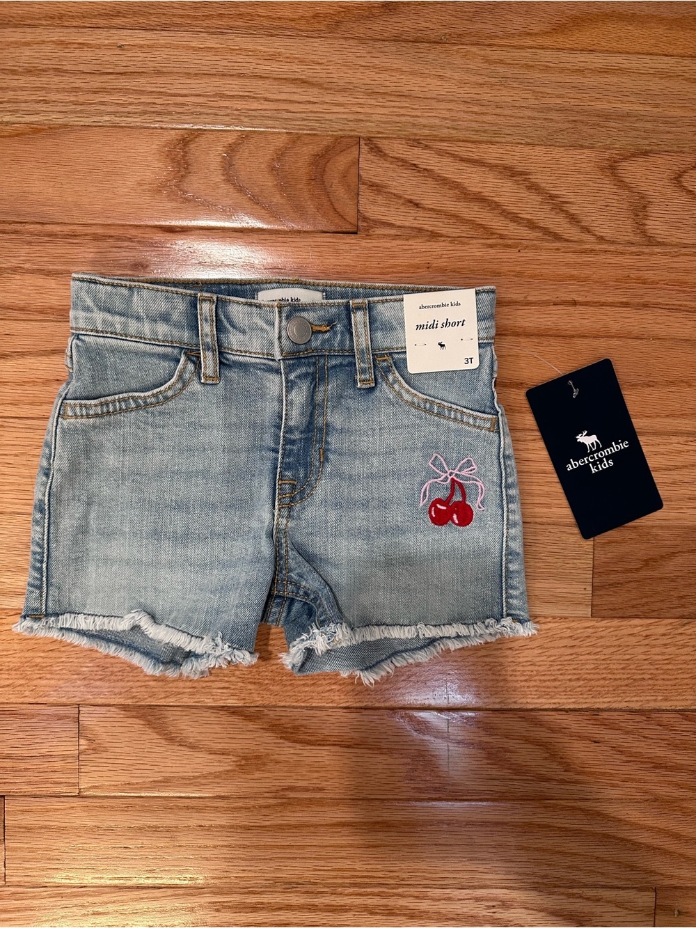 abercrombie kids light blue denim shorts with red cherry patch